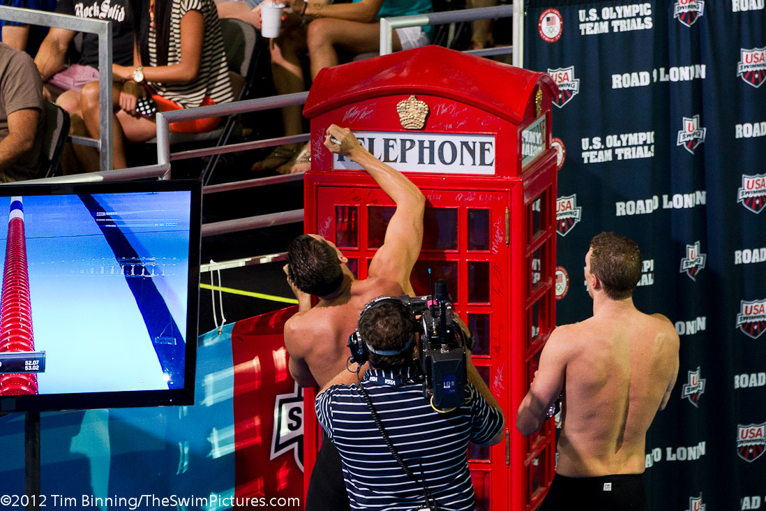 200 breast Olympic team qualifiers Clark Burckle and Scott Weltz sign the phone booth following their swim. | 